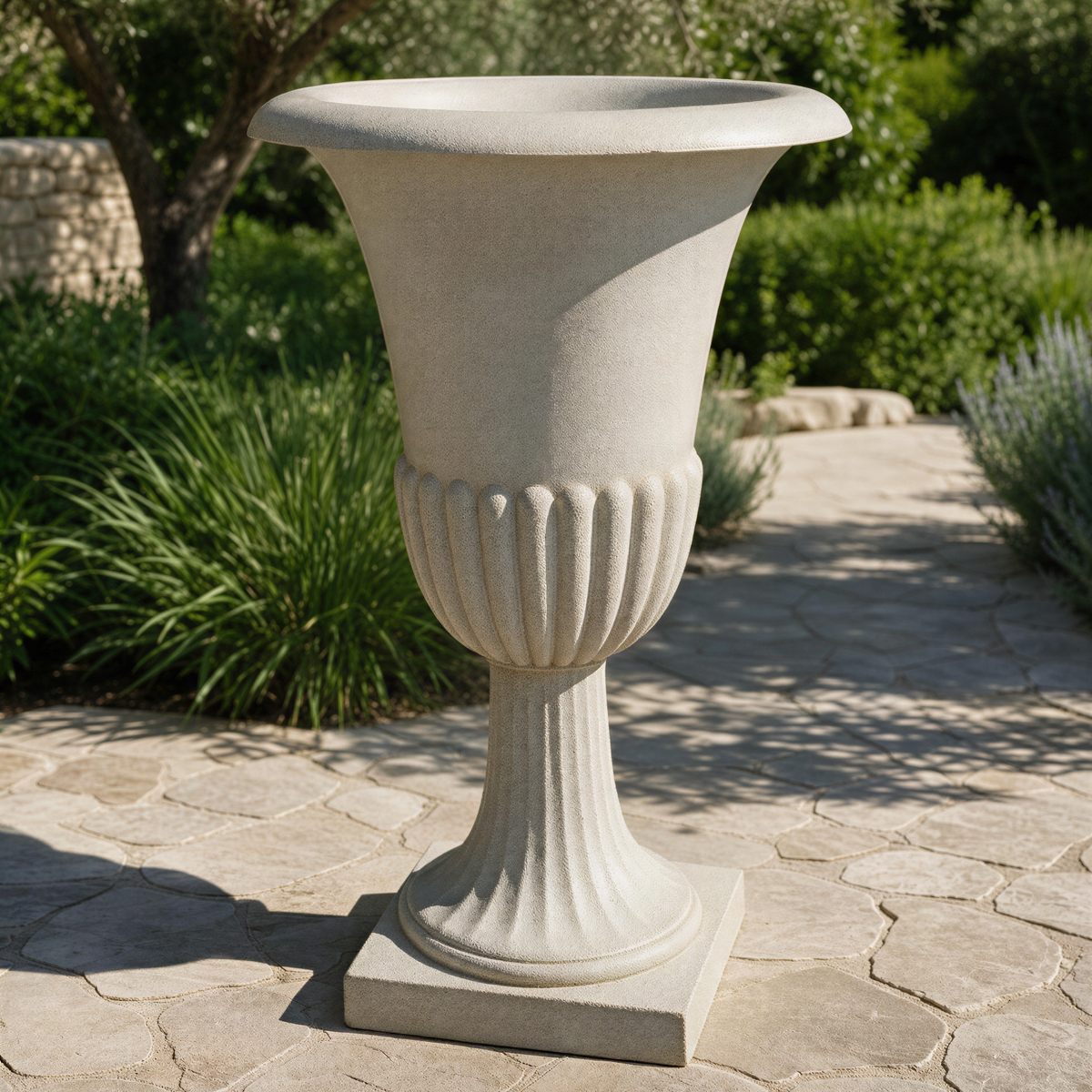 Lutyens Victorian-style European planter in rustic light grey fiberglass, styled in a garden setting